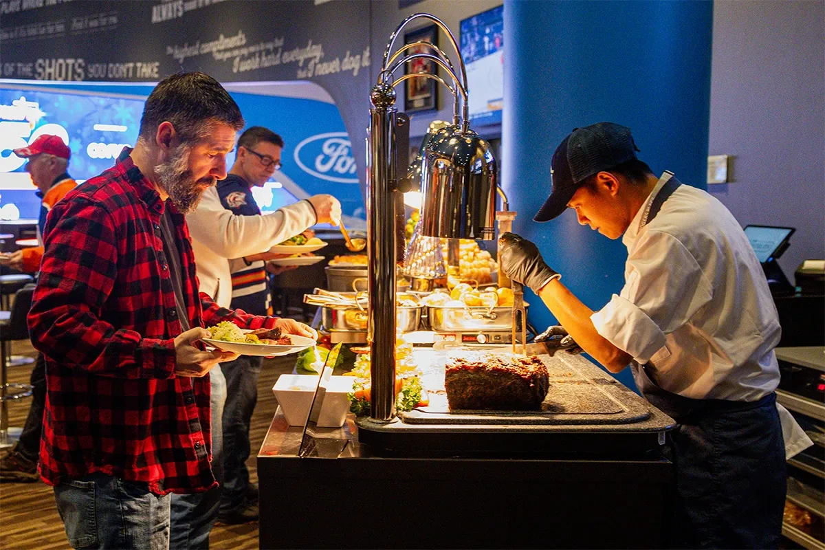 Photo of a fan being served at the Studio 99 buffet