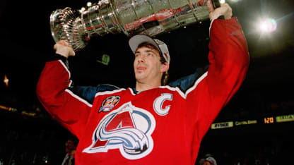 Joe Sakic, captain of the Colorado Avalanche carries the Stanley Cup trophy after defeating the Florida Panthers 1-0 in triple overtime of game four of the Stanley Cup Finals at Miami Arena in Miami, Florida. Sakic was awarded the Conn Smythe