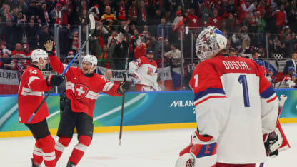 Dean Kukan #14 of Team Switzerland celebrates with teammate Jonas Siegenthaler #71 after scoring a goal to win the game while Lukas Dostal #1 of Team Czechia shows dejection in the overtime during the Men's Preliminary Group A match between Switzerland and Czechia on day nine of the Milano Cortina 2026 Winter Olympic games at Milano Santagiulia Ice Hockey Arena on February 15, 2026 in Milan, Italy. (Photo by Bruce Bennett/Getty Images)