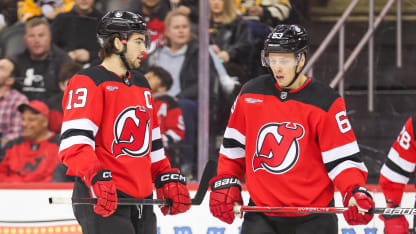 NEWARK, NJ - APRIL 02: New Jersey Devils center Nico Hischier (13) and New Jersey Devils left wing Jesper Bratt (63) look on during a game between the Pittsburgh Penguins and New Jersey Devils on April 2, 2024 at Prudential Center in the Newark, New Jersey.