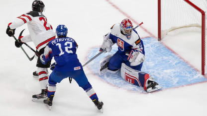 Jakob Pelletier #12 of Canada takes a shot as Rayen Petrovicky #12 and goaltender Samuel Hlavaj #29 of Slovakia defend during the 2021 IIHF World Junior Championship at Rogers Place on December 27, 2020 in Edmonton, Canada. (Photo by Codie McLachlan/Getty Images)