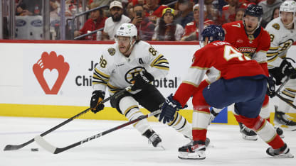 Gustav Forsling #42 of the Florida Panthers defends against David Pastrnak #88 of the Boston Bruins