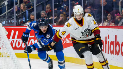 Dominik Badinka #4 of the Chicago Wolves plays the puck away from Colby Barlow #39 of the Manitoba Moose during second period action at Canada Life Centre on November 30, 2025 in Winnipeg, Manitoba, Canada. (Photo by Jonathan Kozub/Getty Images)