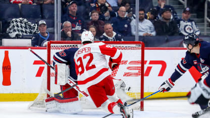 Marco Kasper #92 of the Detroit Red Wings shoots the puck past goaltender Connor Hellebuyck #37 of the Winnipeg Jets for a third period goal at the Canada Life Centre on January 24, 2026 in Winnipeg, Manitoba, Canada. (Photo by Darcy Finley/NHLI via Getty Images)