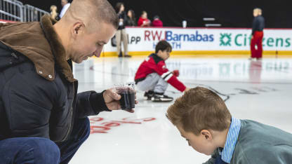 Devils Fans Paint the ice