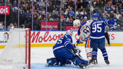 Vasily Podkolzin #92 of the Edmonton Oilers scores against Dennis Hildeby #35 of the Toronto Maple Leafs as his teammate Oliver Ekman-Larsson #95 looks on in the third period at Scotiabank Arena on December 13, 2025 in Toronto, Ontario, Canada. (Photo by Chris Tanouye/Getty Images)