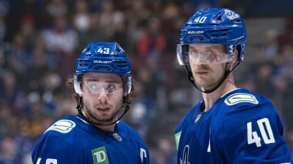 Elias Pettersson #40 and Quinn Hughes #43 of the Vancouver Canucks talk during their NHL game against the New York Rangers at Rogers Arena on November 19, 2024 in Vancouver, British Columbia, Canada. (Photo by Jeff Vinnick/NHLI via Getty Images)