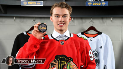 Connor Bedard draft photo holding puck with TM badge