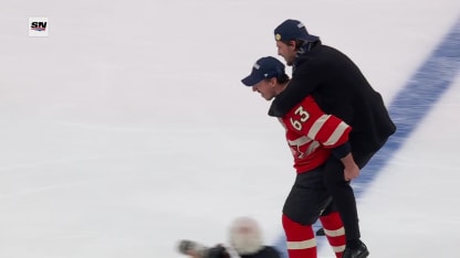 Brad Marchand gives Travis Konecny lift 4 Nations Face-Off medal ceremony