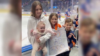 Cal Clutterbuck kids make sign for 1000 NHL games