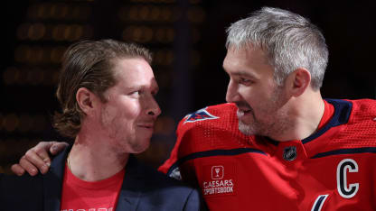 Nicklas Backstrom #19 of the Washington Capitals and Alex Ovechkin #8 of the Washington Capitals look at one another as John Carlson is acknowledged for playing in his 1000th NHL game before playing against the Ottawa Senators at Capital One Arena on April 07, 2024 in Washington, DC. (Photo by Patrick Smith/Getty Images)