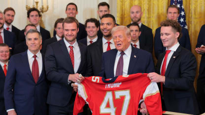 U.S. President Donald Trump is presented with a jersey and hockey stick by Florida Panthers owner Vincent Viola (L), Aleksander Barkov and Matthew Tkachuk of the Florida Panthers during a ceremony to honor the 2025 Stanley Cup Champion Florida Panthers in the East Room of the White House on January 15, 2026 in Washington, DC. The Florida Panthers defeated the Edmonton Oilers for the second straight year in their first-ever championships since joining the NHL in 1993. (Photo by Anna Moneymaker/Getty Images)