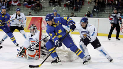 Mats Sundin #13 of Sweden tries to bring the puck around the net past Kimmo Timonen #4 of Finland during the final of the men's ice hockey match between Finland and Sweden during Day 16 of the Turin 2006 Winter Olympic Games on February 26, 2006 at the Palasport Olimpico in Turin, Italy. (Photo by Elsa/Getty Images)