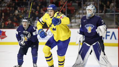 Milton Oscarson #25 of Team Sweden skates for the puck against Ville Ruotsalainen #4 of Team Finland in the third period of a Quarterfinal game during the 2023 IIHF World Junior Championship at Avenir Centre on January 2, 2023 in Moncton, Canada. (Photo by Dale Preston/Getty Images)