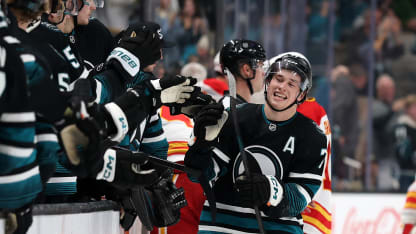Macklin Celebrini #71 of the San Jose Sharks is congratulated by teammates after he scored an empty-net goal against the Calgary Flames for his second goal of the third period at SAP Center on December 16, 2025 in San Jose, California. (Photo by Ezra Shaw/Getty Images)