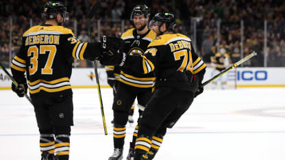 Patrice Bergeron #37 of the Boston Bruins celebrates with Jake DeBrusk #74 and Pavel Zacha #18 after scoring a goal against the Dallas Stars during the third period at TD Garden on October 25, 2022 in Boston, Massachusetts. The Bruins defeat the Stars 3-1. (Photo by Maddie Meyer/Getty Images)