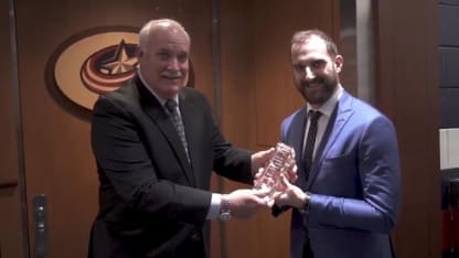 Photo of Nick Foligno posing for a photo with President of Hockey Operations, John Davidson while accepting an award.