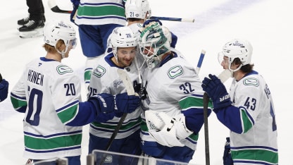 Teammates congratulate goaltender Kevin Lankinen #32 of the Vancouver Canucks