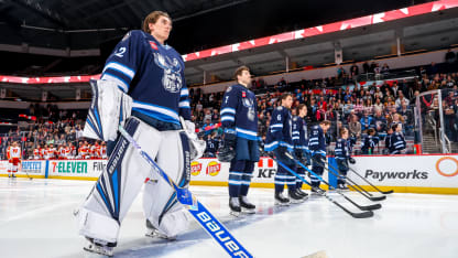 WINNIPEG, CANADA - FEBRUARY 14: Goaltender Thomas Milic #32, Walker Duehr #7, Ashton Sautner #6, Tyrel Bauer #2, David Gustafsson #27, and Mason Shaw #18 of the Manitoba Moose stand on the blue line prior to AHL action against the Calgary Wranglers at Canada Life Centre on February 14, 2026 in Winnipeg, Manitoba, Canada. (Photo by Jonathan Kozub/Getty Images)
