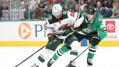 Ryan Hartman #38 of the Minnesota Wild advances the puck under pressure from Tyler Myers #57 of the Dallas Stars during the second period at American Airlines Center on April 09, 2026 in Dallas, Texas. (Photo by Stacy Revere/Getty Images)