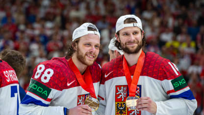 David Pastrnak and Pavel Zacha #14 of Czechia celebrate their victory with the gold medal during the 2024 IIHF Ice Hockey World Championship Czechia Gold Medal Match between Switzerland and Czechia at Prague Arena on May 26, 2024 in Prague, Czech Republic. (Photo by RvS.Media/Monika Majer/Getty Images)