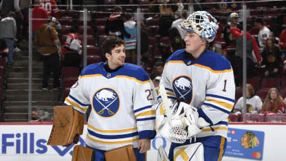 Goalies Devon Levi #27 and Ukko-Pekka Luukkonen #1 of the Buffalo Sabres celebrate after defeating the Chicago Blackhawks