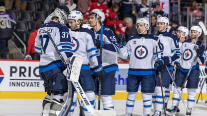 Connor Hellebuyck #37 of the Winnipeg Jets celebrates the victory with teammates after the game against the Detroit Red Wings at Little Caesars Arena on October 30, 2024 in Detroit, Michigan. Winnipeg defeated Detroit 6-2. (Photo by Dave Reginek/NHLI via Getty Images)