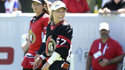 Brooke Henderson in Senators jersey on golf course