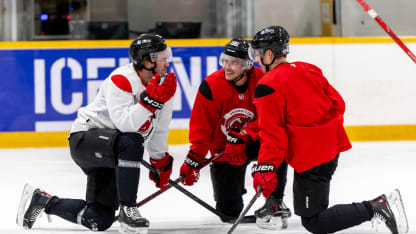 Nico Hischier #13, Jack Hughes #86, and Jesper Bratt #63 of the New Jersey Devils talk during practice prior to the 2024 NHL Global Series Challenge