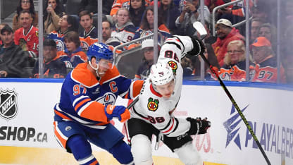 Connor McDavid #97 of the Edmonton Oilers skates against Connor Bedard #98 of the Chicago Blackhawks