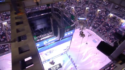 Servicemen rappel from rafters for puck drop