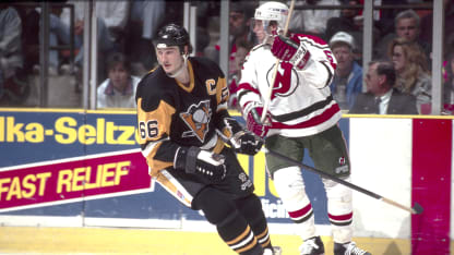 E.RUTHERFORD, NJ - MARCH 19: Pittsburgh Penguins forward, Mario Lemieux, breaks away from Devils defenseman, Eric Weinrich, during the game against the NJ Devils at the Meadowlands Arena, East Rutherford, NJ, United States on March 19, 1991. (Photo by Steve Crandall/Getty Images)