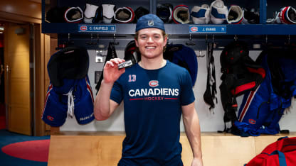 Cole Caufield #13 of the Montreal Canadiens poses with his 40th goal of the season puck with teammates after the game winning overtime goal in the NHL regular season game against the Boston Bruins at the Bell Centre on March 17, 2026 in Montreal, Quebec, Canada. (Photo by Matt Garies/NHLI via Getty Images)