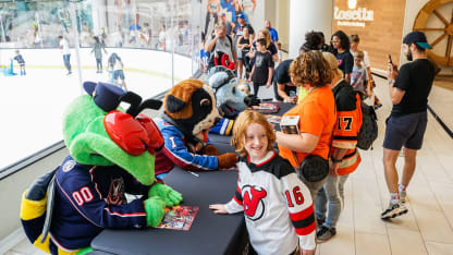 Mascots sign autographs at American Dream.