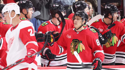 Teuvo Teravainen #86 of the Chicago Blackhawks high fives teammates after scoring a goal against the Detroit Red Wings