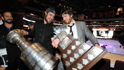 Anze Kopitar (L) of the Los Angeles Kings holds the Stanley Cup as teammate Jonathan Quick holds the Conn Smythe Trophy during the team party after the Kings defeated the New Jersey Devils 6-1 to win the Stanley Cup series 4-2 in Game Six of the 2012 Stanley Cup Final on June 12, 2012 at Staples Center in Los Angeles, California. (Photo by Juan Ocampo/NHLI via Getty Images)