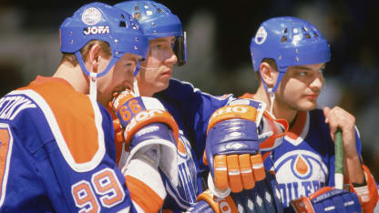 Wayne Gretzky #99, Jari Kurri #17 and Esa Tikkanen #10 of the Edmonton Oilers take a rest during a break in the action in a game against the New York Islanders at Nassau Coliseum, Uniondale, New York, mid 1980s. (Photo by Bruce Bennett Studios via Getty Images Studios/Getty Images)