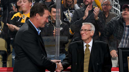 Mike Lange shakes hands with Mario Lemieux during a ceremony honoring his 45 years as Pittsburgh Penguins broadcaster at PPG PAINTS Arena on October 8, 2019 in Pittsburgh, Pennsylvania. (Photo by Joe Sargent/NHLI via Getty Images)