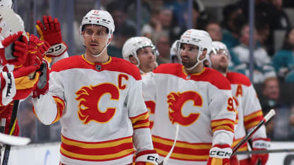 Mikael Backlund #11 of the Calgary Flames celebrates with teammates on the bench after scoring a power-play goal against the San Jose Sharks during the second period of the NHL game at SAP Center on December 28, 2024 in San Jose, California. The Flames defeated the Sharks 3-1. (Photo by Christian Petersen/Getty Images)