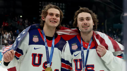 Jack Hughes #86 and Quinn Hughes #43 of Team United States celebrate following the Men's Gold Medal match between Canada and the United States on day 16 of the Milano Cortina 2026 Winter Olympic games at Milano Santagiulia Ice Hockey Arena on February 22, 2026 in Milan, Italy. Team United States defeated Team Canada 2-1 in overtime to win the Gold medal. (Photo by Elsa/Getty Images)