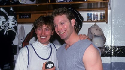 INGLEWOOD, CA - MARCH 23: Wayne Gretzky #99 of the Los Angeles Kings poses with his teammate Marty McSorley #33 and the puck he scored his 802nd career goal with after the game against the Vancouver Canucks on March 23, 1994 at the Great Western Forum in Inglewood, California. Gretzky passed Gordie Howe for most career goals. (Photo by B Bennett/Getty Images)