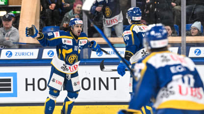 Simon Knak of HC Davos (C) celebrates his goal with Andres Ambuhl of HC Davos (L) during the Spengler Cup Davos match between HC Davos v Kärpät Oulu at Eisstadion Davos on December 29, 2024 in Davos, Switzerland. (Photo by Andrea Branca/Eurasia Sport Images/Getty Images)