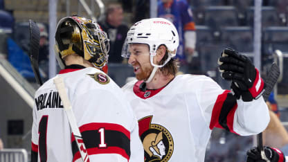 Leevi Merilainen #1 and Jake Sanderson #85 of the Ottawa Senators celebrate the 2-0 win against the New York Islanders at UBS Arena on January 14, 2025 in Elmont, New York. (Photo by Mike Stobe/NHLI via Getty Images)