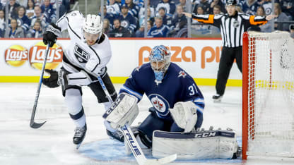 Adrian Kempe #9 of the Los Angeles Kings and goaltender Connor Hellebuyck #37 of the Winnipeg Jets keep an eye on the loose puck during third period action at the Bell MTS Place on October 9, 2018 in Winnipeg, Manitoba, Canada. (Photo by Darcy Finley/NHLI via Getty Images)