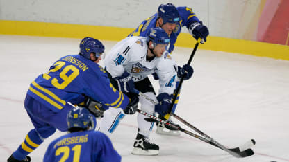 Saku Koivu #11 of Finland tries to get past Mats Sundin #13 and Kenny Jonsson #29 both of Sweden during the final of the men's ice hockey match between Finland and Sweden during Day 16 of the Turin 2006 Winter Olympic Games on February 26, 2006 at the Palasport Olimpico in Turin, Italy. (Photo by Brian Bahr/Getty Images)