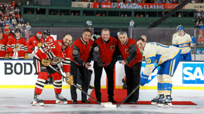 Chicago Blackhawks captain Nick Foligno #17 and St. Louis Blues captain Brayden Schenn #10 perform the ceremonial puck drop with Chris Chelios, Jeremy Roenick and Denis Savard at the Discover NHL Winter Classic at Wrigley Field on December 31, 2024 in Chicago, Illinois. (Photo by Chase Agnello-Dean/NHLI via Getty Images)