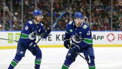 Quinn Hughes #43 and Elias Pettersson #40 of the Vancouver Canucks skate up ice during their NHL game against the Anaheim Ducks at Rogers Arena on March 31, 2024 in Vancouver, British Columbia, Canada. (Photo by Jeff Vinnick/NHLI via Getty Images)