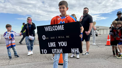 UTAH young fan holding welcome sign