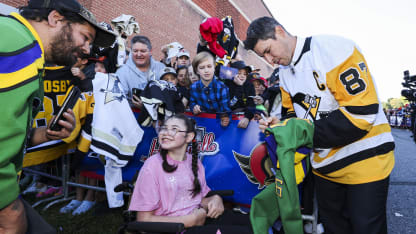 Crosby signs autograph for young girl