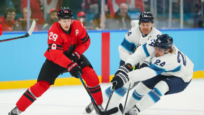 Nathan MacKinnon #29 of Team Canada compete for the puck against Roope Hintz #24 and Mikael Granlund #64 of Team Finland in the first period during the Men's Semifinals Playoff match between Canada and Finland on day fourteen of the Milano Cortina 2026 Winter Olympic games at Milano Santagiulia Ice Hockey Arena on February 20, 2026 in Milan, Italy. (Photo by Gregory Shamus/Getty Images)